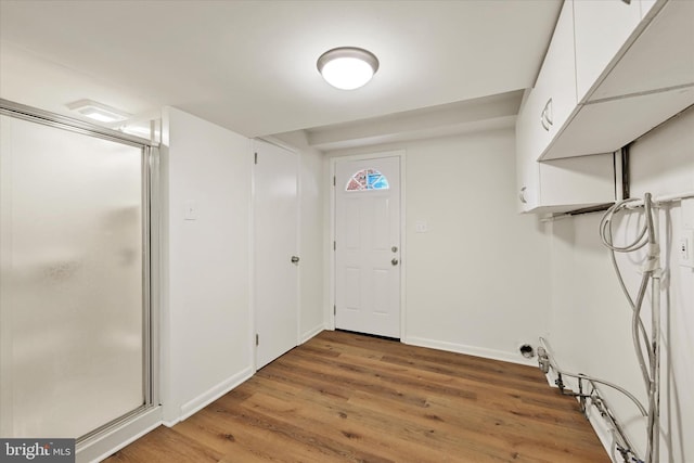 washroom with light wood-style floors and baseboards