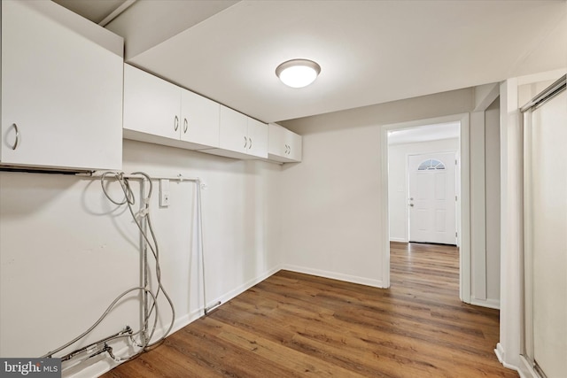laundry room with wood finished floors and baseboards
