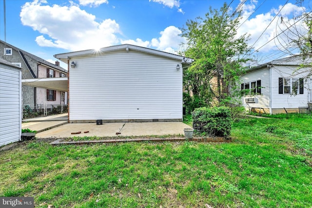 rear view of house featuring a patio and a yard