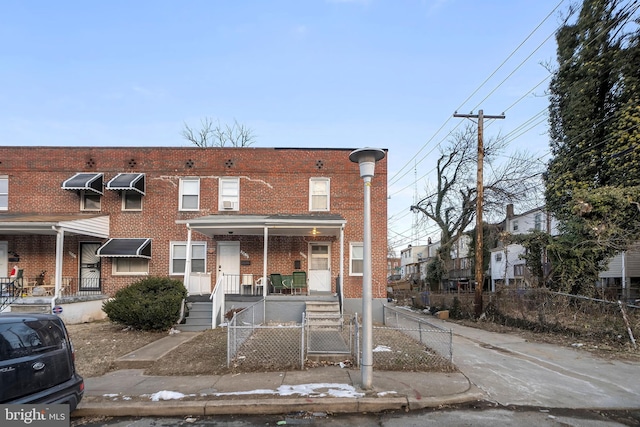 townhome / multi-family property with a porch