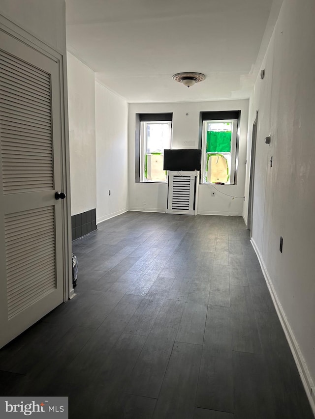 unfurnished living room with dark hardwood / wood-style flooring