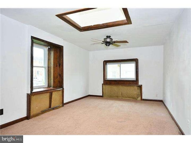 carpeted spare room featuring a wealth of natural light