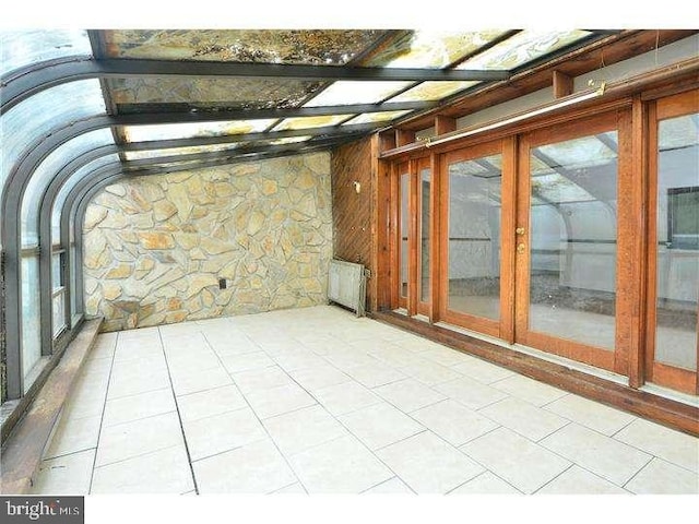 empty room with radiator heating unit and wooden walls