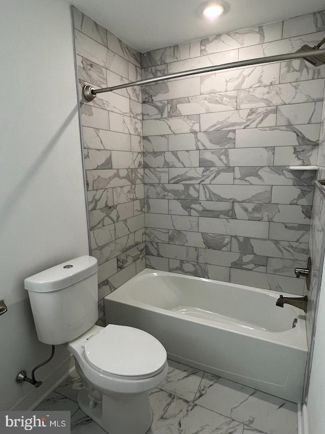 bathroom featuring toilet and tiled shower / bath combo