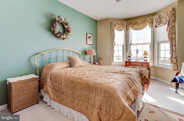 carpeted bedroom featuring multiple windows