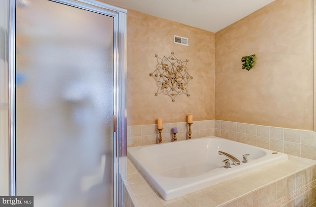 bathroom featuring tiled bath