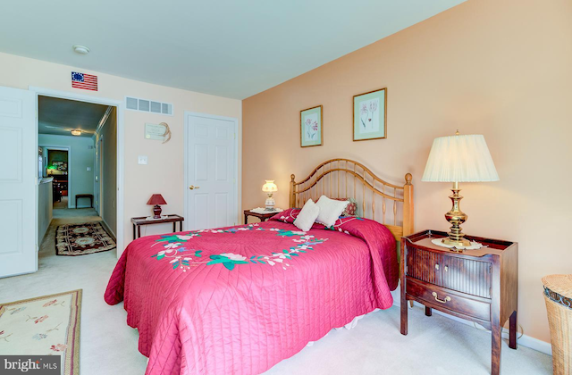 bedroom featuring light carpet