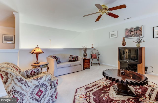 carpeted living room with ceiling fan