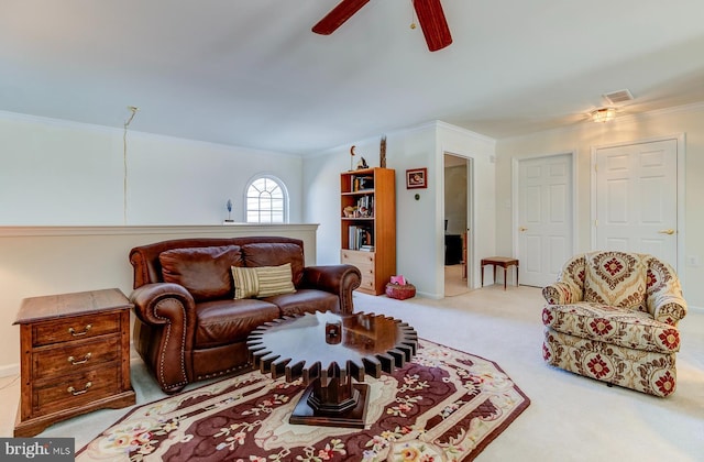 living room featuring ornamental molding, light carpet, and ceiling fan