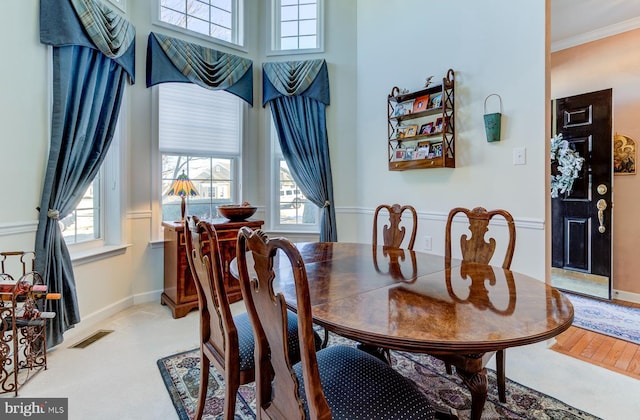 dining space with a wealth of natural light and ornamental molding