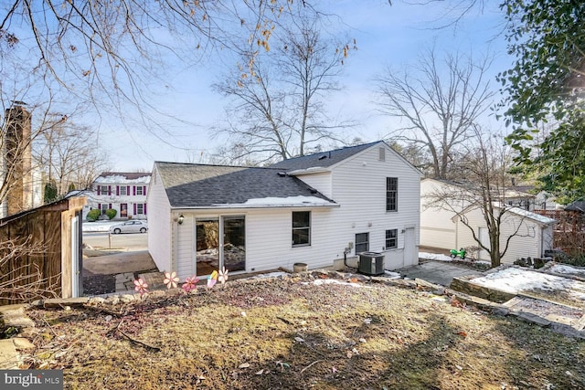 rear view of house with central AC unit