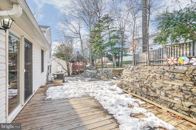 snow covered deck featuring central AC and a gazebo