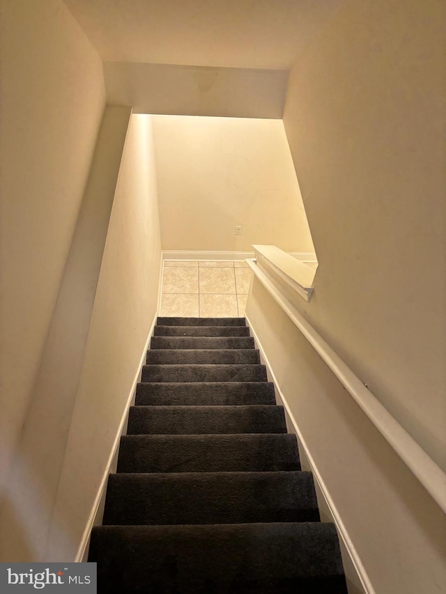 staircase with tile patterned flooring