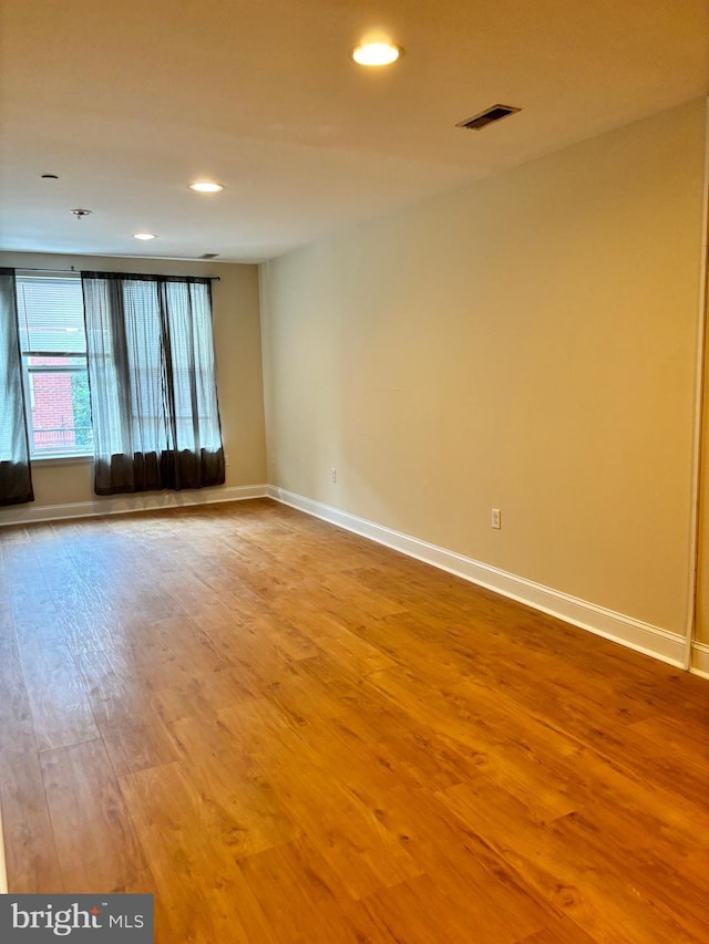 spare room featuring light hardwood / wood-style floors