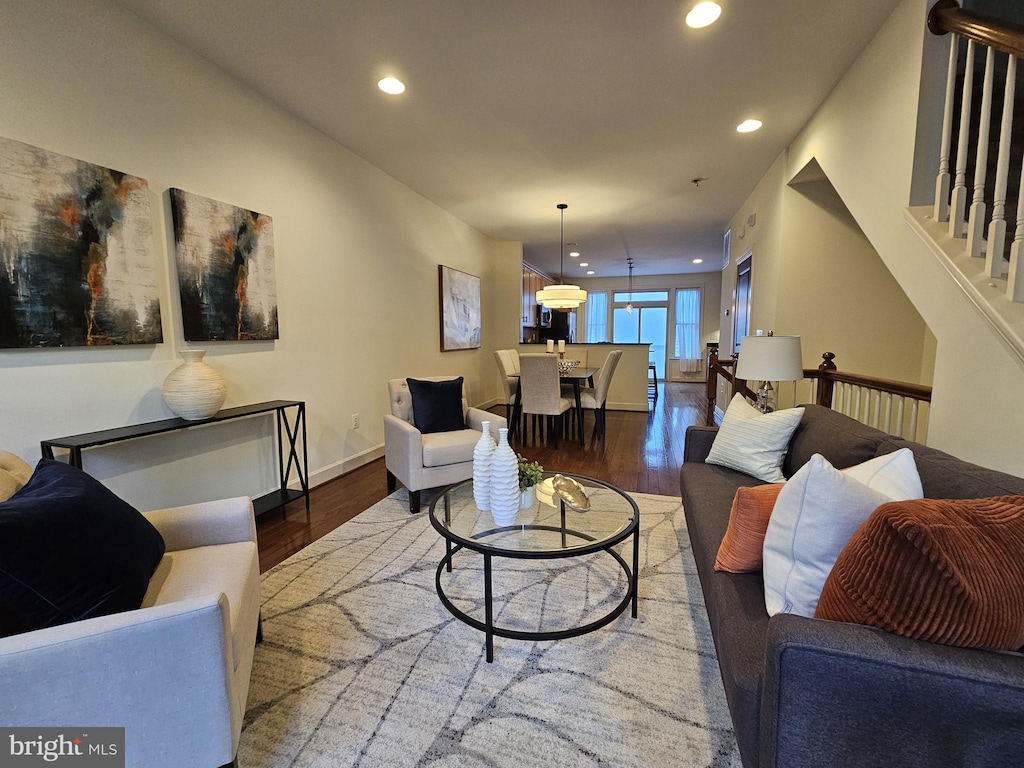 living room with dark hardwood / wood-style flooring