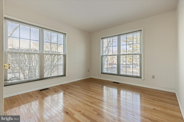 empty room with light hardwood / wood-style flooring