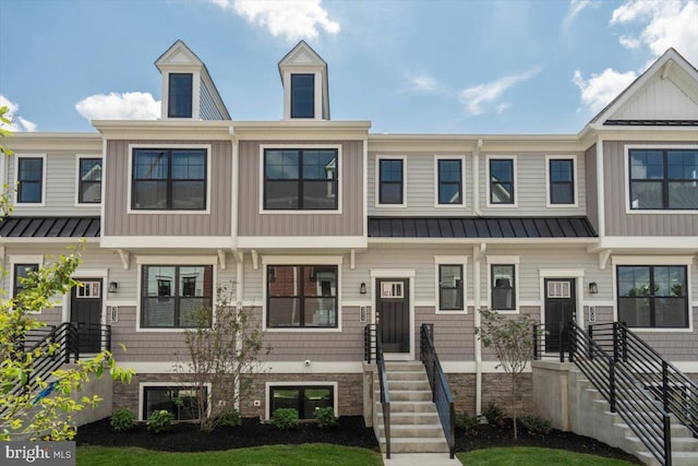 townhome / multi-family property featuring a standing seam roof and metal roof