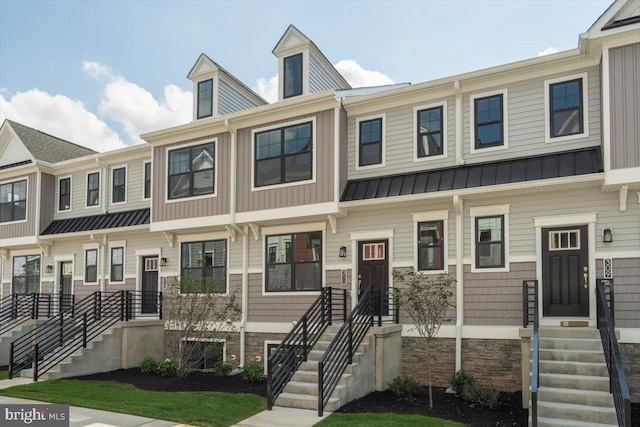 townhome / multi-family property featuring a standing seam roof and metal roof