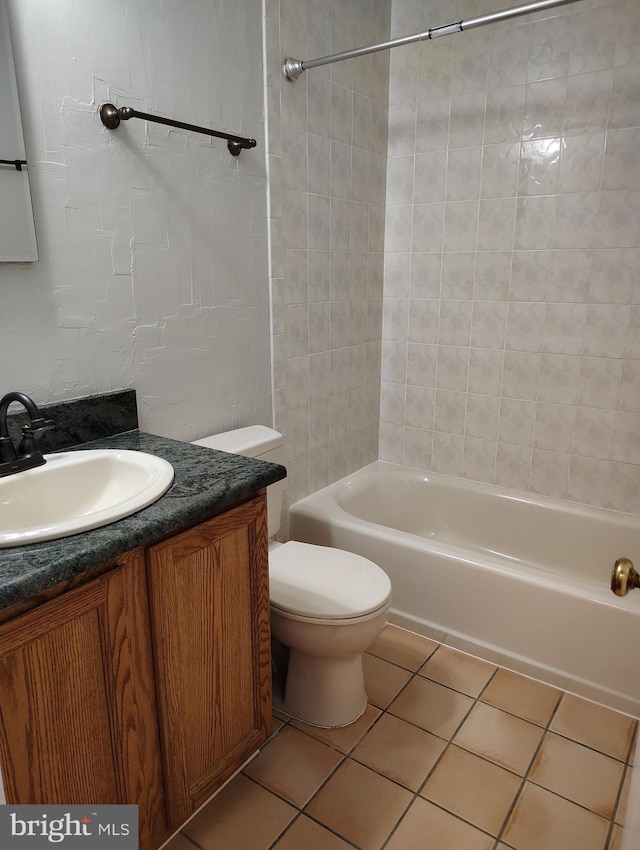 full bathroom with shower / bath combination, toilet, vanity, and tile patterned flooring