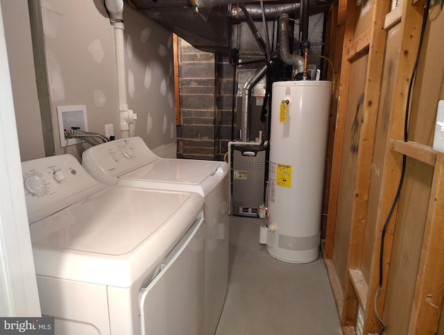 washroom featuring washer and dryer, water heater, and laundry area