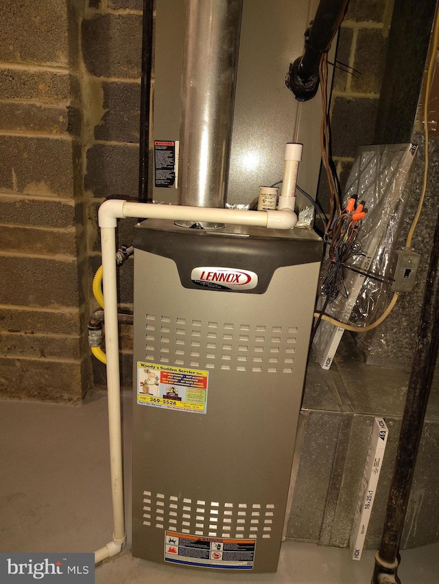 utility room featuring heating unit