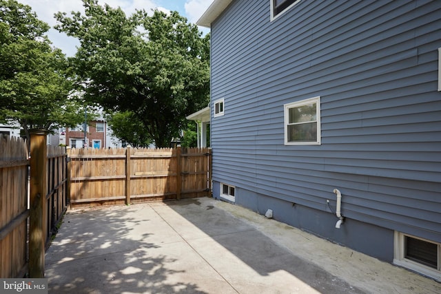 view of side of property with fence and a patio area