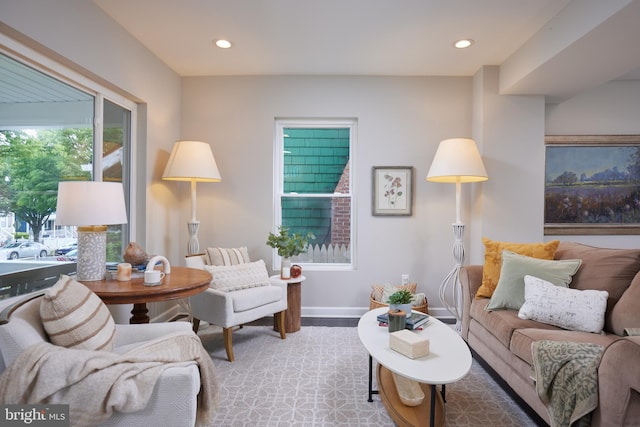 living area with recessed lighting, wood finished floors, and baseboards