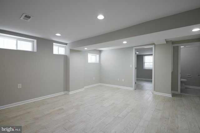 basement featuring light wood-style floors, recessed lighting, and baseboards