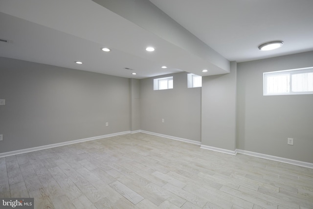 basement featuring light wood-style floors, recessed lighting, and baseboards