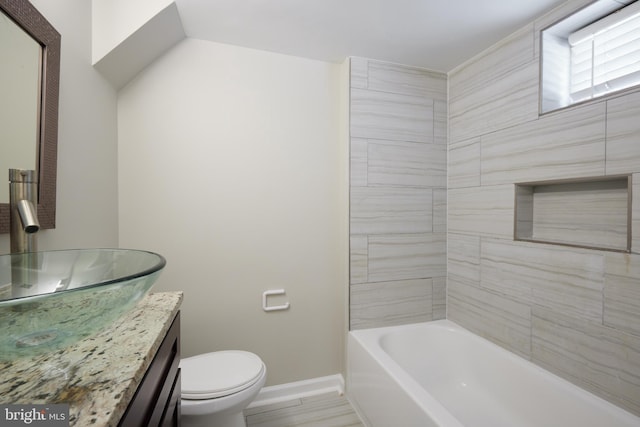 full bathroom featuring vanity, baseboards, and toilet