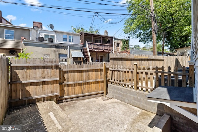 back of house with a fenced backyard
