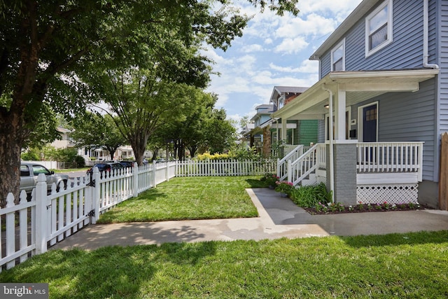 view of yard with covered porch