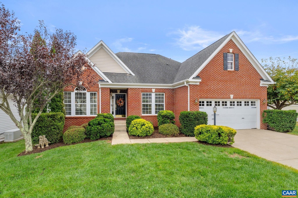 view of property with a garage and a front lawn