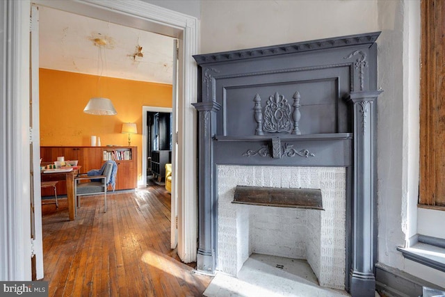 interior details featuring a fireplace and wood-type flooring