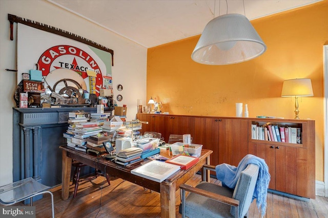 dining area with hardwood / wood-style floors and wooden walls