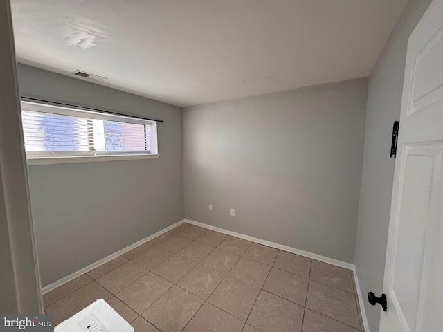 empty room with light tile patterned floors