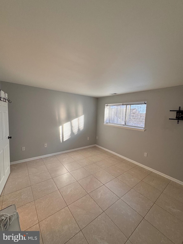 unfurnished room featuring light tile patterned flooring