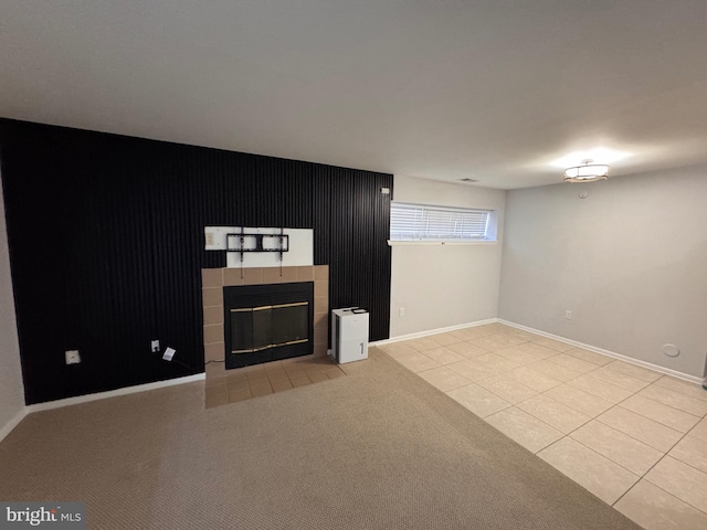 unfurnished living room featuring light tile patterned floors and a fireplace