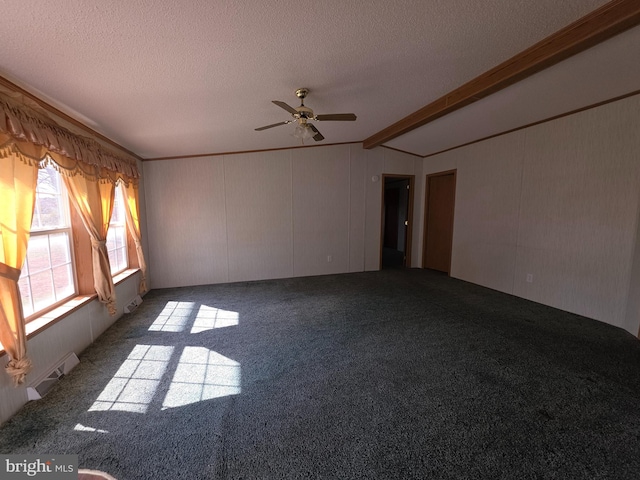 spare room featuring a textured ceiling, carpet, and vaulted ceiling with beams