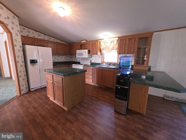 kitchen with white appliances, wallpapered walls, arched walkways, lofted ceiling, and a sink