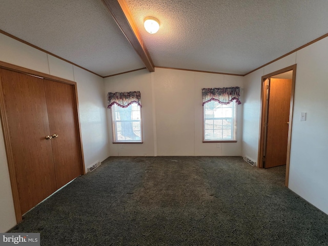 interior space with a textured ceiling, lofted ceiling with beams, carpet flooring, visible vents, and crown molding