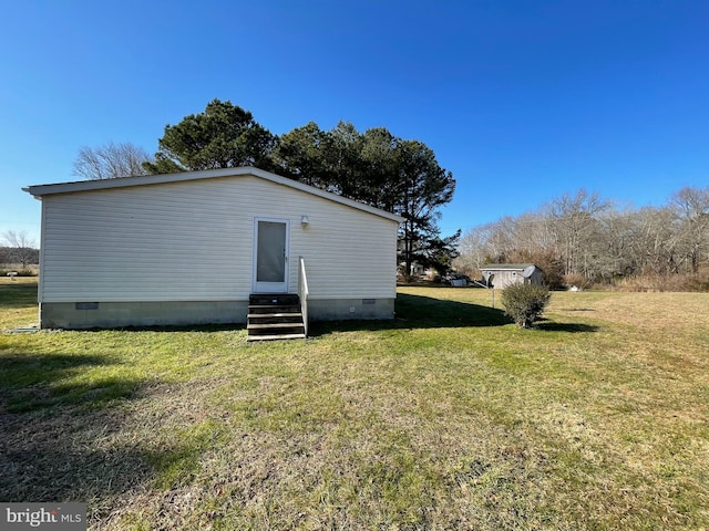 view of property exterior featuring crawl space, a yard, and entry steps