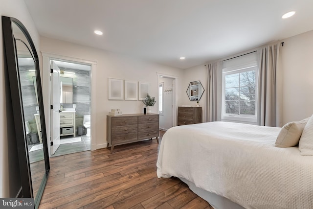 bedroom with dark hardwood / wood-style flooring and connected bathroom