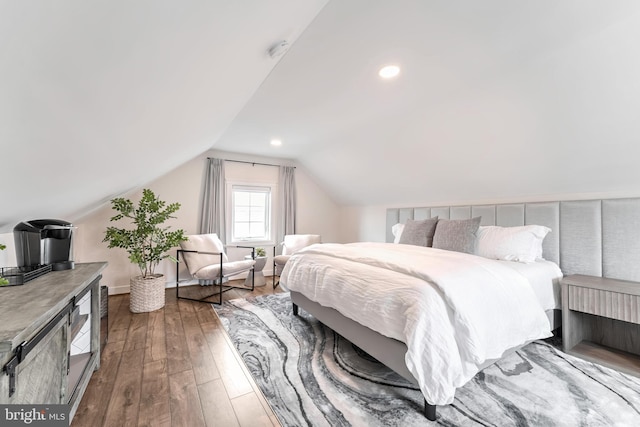 bedroom with lofted ceiling and hardwood / wood-style flooring