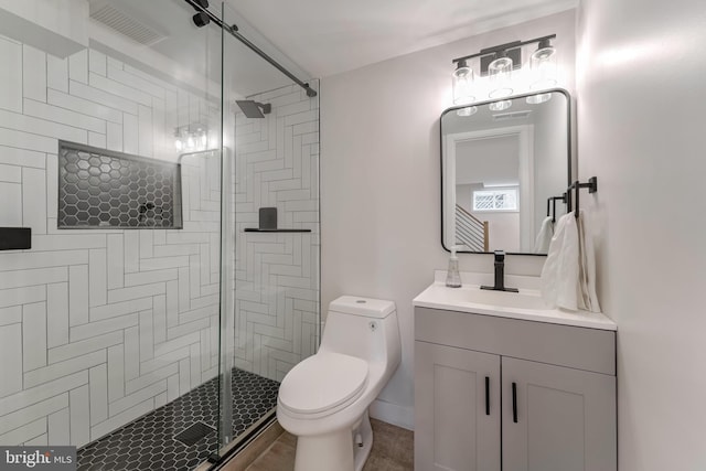 bathroom featuring walk in shower, vanity, and toilet