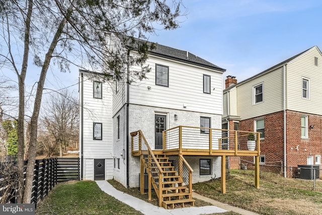 back of property with a wooden deck and central air condition unit