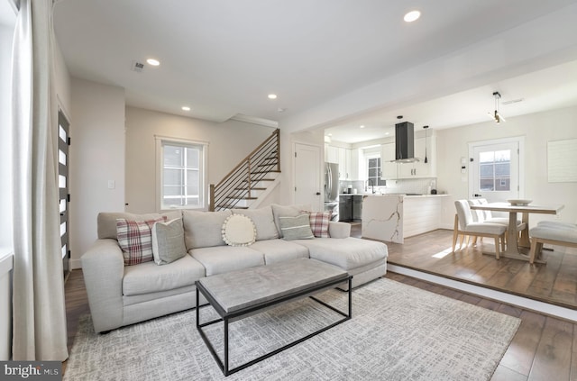 living room featuring sink and light hardwood / wood-style floors