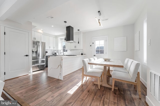 dining area featuring sink and hardwood / wood-style flooring