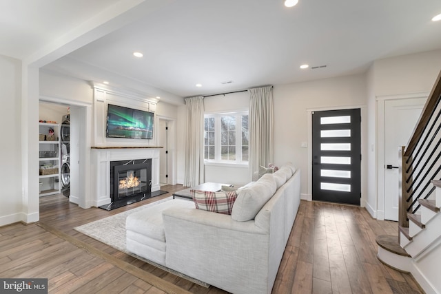 living room featuring hardwood / wood-style floors and a high end fireplace