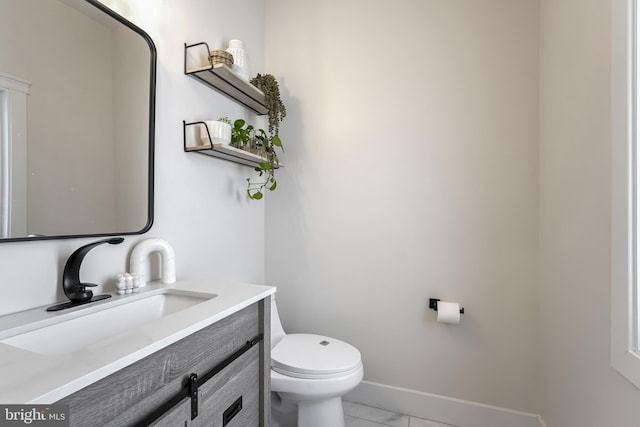 bathroom featuring vanity, tile patterned floors, and toilet